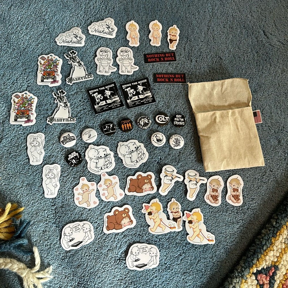 Assortment of pins and stickers with bag included